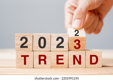 hand flipping block 2022 to 2023 TREND text on table. Resolution, idea, goal, motivation, reboot, business and New Year holiday concepts - Shutterstock ID 2201991195