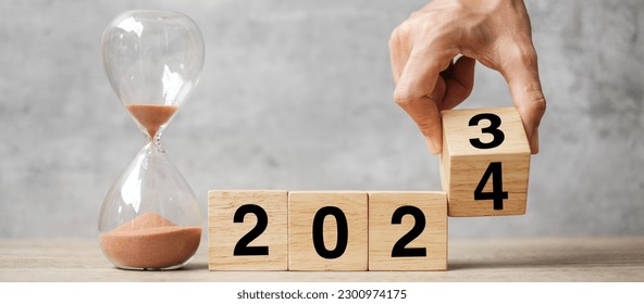 hand flipping block 2023 to 2024 text with hourglass on table. Resolution, time, plan, goal, motivation, reboot, countdown  and New Year holiday concepts - Shutterstock ID 2300974175