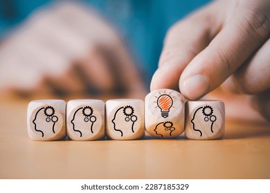 Hand flipping to change human thinking icon to lightbulb lamp glowing icon for creative thinking idea and problem solving concept. - Shutterstock ID 2287185329