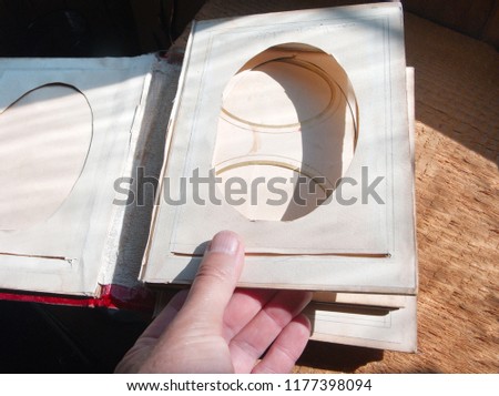 A hand flipping empty pages of the old picture album, concept of flashback