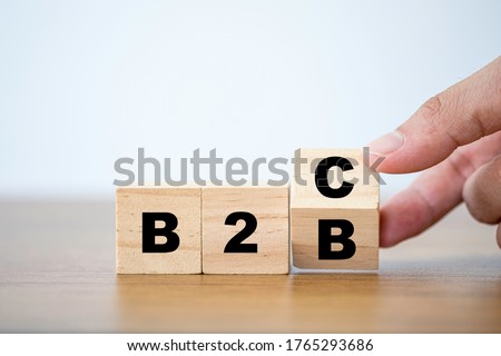 Hand flipping wooden cubes block for change wording B2B to B2C. supply change between Business supplier and customer relations concept.