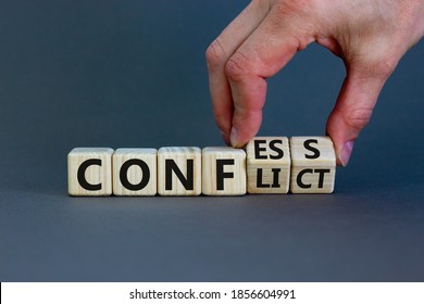 Hand flips cubes and changes the expression 'conflict' to 'confess' or vice versa. Beautiful grey background. Concept. Copy space.