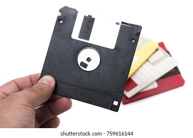 hand with floppy disk isolated on a white background.