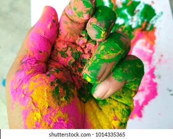 Hand full of colours during Holi festival of India