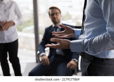 Hand gesture of male business leader talking to employees at meeting in office. Mentor, teacher giving workshop, instructions to interns. Project group brainstorming on ideas - Shutterstock ID 2179177869