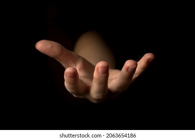 Hand gesture on a black background, palm up holding something, mockup and template for presentation concept  - Powered by Shutterstock