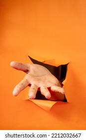 Hand Gesture On Torn Orange Paper Background