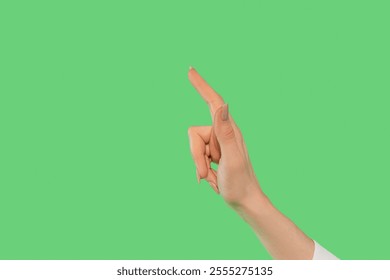 Hand gesture pointing upwards against a bright green background showing direction and intention clearly - Powered by Shutterstock