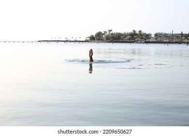 Hand Gesture Of A Sinking Man In The Sea