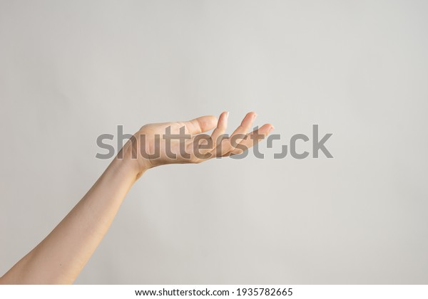 Hand\
gestures. Elegant female hand, pointing to the\
side