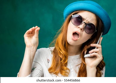 Hand gesture,Woman speaking with smartphone and shows keep silence with hand.Girl get tired to speak on mobile phone,don`t want listen.Hand shows stop blah blah symbol of speaking mouth