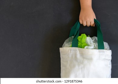 Hand Girl Holding Canvas Tote Bag On Black Background, Save Environmental And Recycle Concept