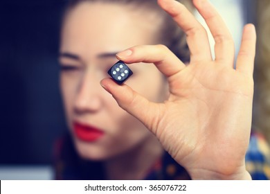 Hand girl holding a dice for a game of backgammon. - Shutterstock ID 365076722