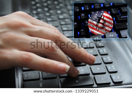 Hand of the girl on the keyboard close up with the concept of digital technology on the purchase and sale of crypto currency bitcoin with a flag of Bikini Atoll. The concept of network, communication