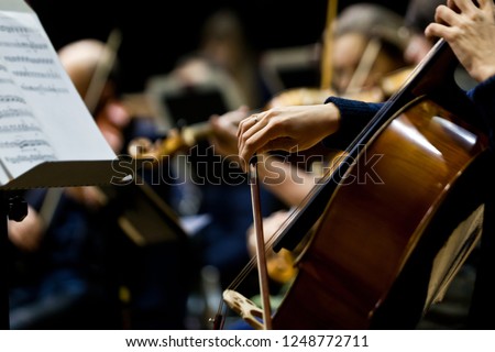 Hand girl playing cello closeup 