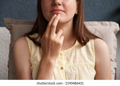Hand of a girl practicing EFT or emotional freedom technique - tapping under the mouth - Shutterstock ID 2190486431