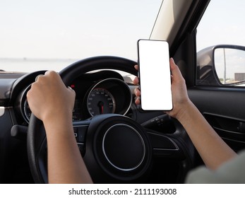 hand of a girl using a phone while driving a car - Powered by Shutterstock