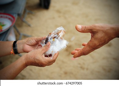 Hand Give Food To Hands Of A Beggar