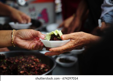 Hand Give Food To Hands Of A Beggar