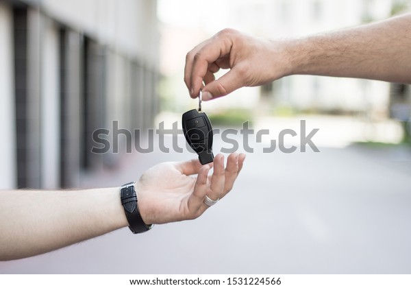 Hand gives the car\
key