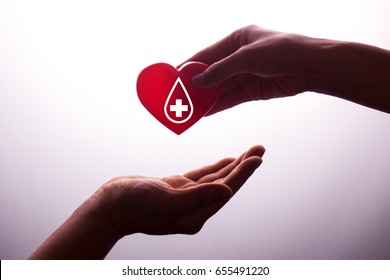 A Hand Gives A Red Heart To A Hand - Blood Donation,world Blood Donor Day