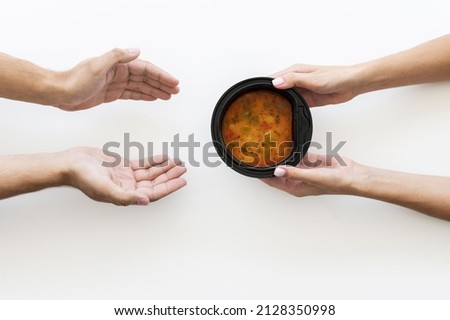 hand giving bowl soup needy person