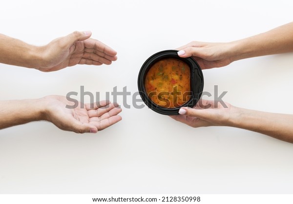 hand giving bowl soup needy\
person