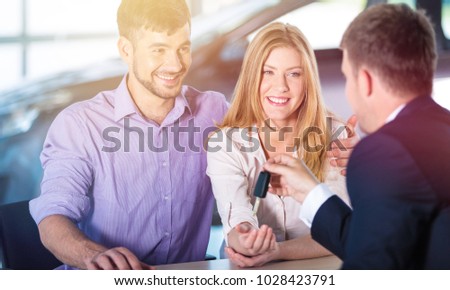 Hand giving car key