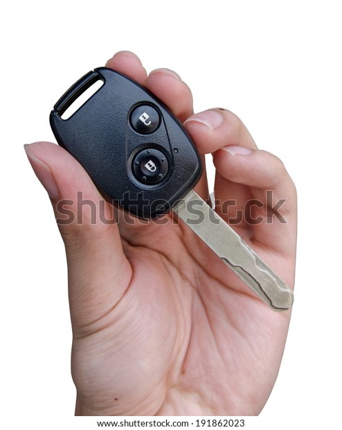 Hand\
giving a car key. Isolated on white\
background.