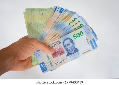 Hand giving mexican pesos money papers