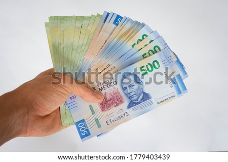 Hand giving mexican pesos money papers