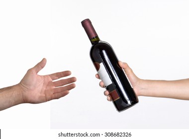 Hand Giving Red Wine Bottle.