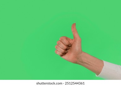 A Hand Giving a Thumbs up Against a Vibrant Green Background in a Cheerful Display of Approval - Powered by Shutterstock