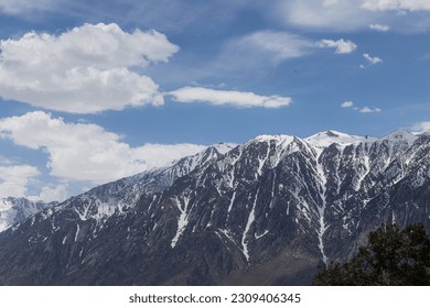 Hand glider soaring above the snow covered eastern Sierra Nevadas spring of 2023 - Powered by Shutterstock