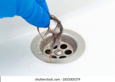 Hand In Glove Cleaning A Clogged Sink Or Bathtub Drain From Hair