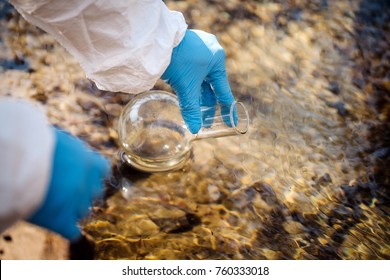 Hand In Glove Collects Water In A Test Tube.