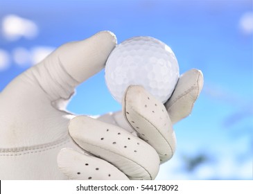 Hand In Glove Holding Golf Ball