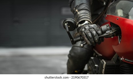 Hand in glove on motorcycle handlebar, free space for insertion