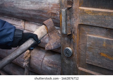 A Hand In Glove Pressing The Door With An Axe, Concept Of Home Invasion