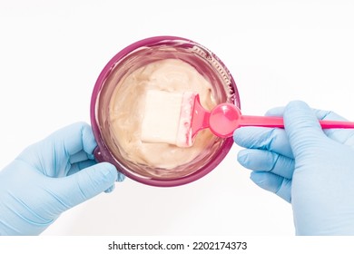 Hand With Gloves Preparing Hair Dye. White Background Top View