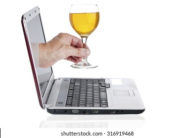 Hand With Goblet With Wine Comes From The Laptop Screen