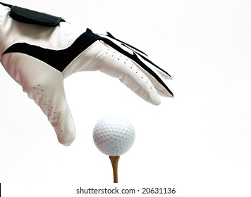 Hand With Golf Glove Picking Up A Ball From The Tee