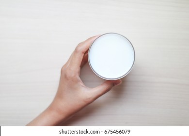 Hand Grab A Glass Of Milk Top View