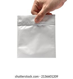 Hand Grabbing White Certified Medical Marijuana Bag With White Background Isolated