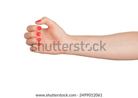 Hand grasping virtual object. Arm gesture holding empty space, product. Woman with red manicure, varnished nails, elegant body language. Closeup of delicate, outstretched fingers..