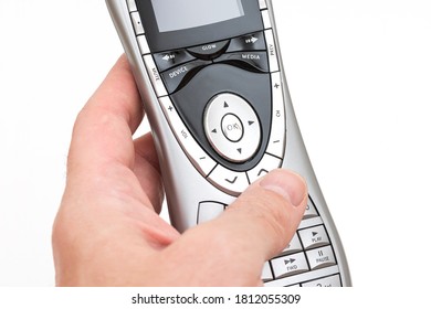 Hand with gray remote control on the white background. - Shutterstock ID 1812055309