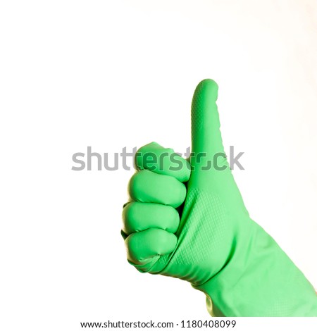 A hand in green glove on a white background, isolated
