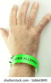 A Hand With A Green Latex Allergy Bracelet Around Wrist