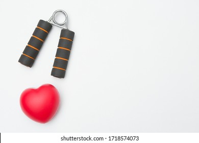 Hand Grip And Heart Shaped Squeeze Ball For Hand Muscle Exercise On White Background And Copy Space