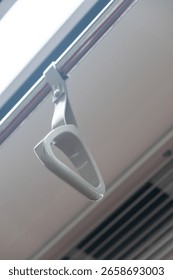 Hand grip inside the train of SRT Dark Red Line. It is a rapid transit line operated as part of the MBTA subway system from Bangkok to Rangsit